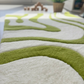 Green and white patterned rug on a floor with blurred background
