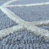Picture of a rug featuring textured arch designs in neutral colors