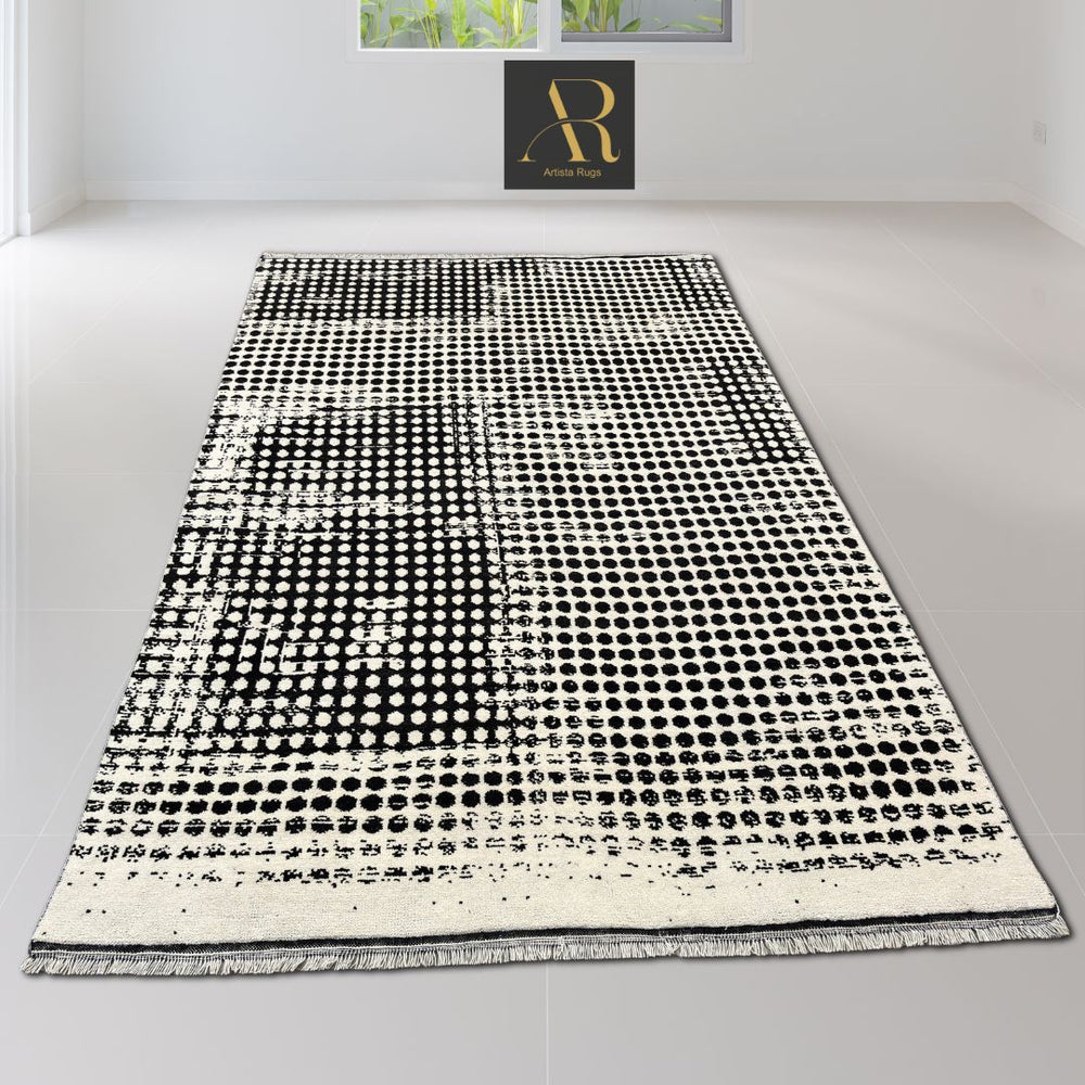  black and white hand-knotted rug with a round design and textured pattern