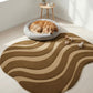 Dog resting on a round pet bed with a wavy patterned rug in a bright room.