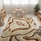 Children's playroom with a patterned rug, wooden table, chairs, and toys.
