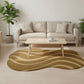 Beige sofa in a living room with a wavy patterned rug and a coffee table.