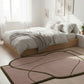Modern bedroom with a pink rug on light wood flooring