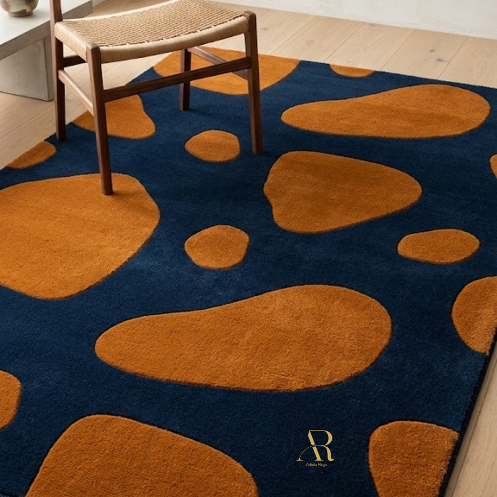 Rug with orange abstract shapes on a blue background, placed in a room with a chair.