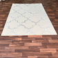 Beige patterned rug on a wooden floor