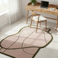 Modern office setup with a decorative rug, desk, chair, and laptop.