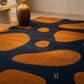 Rug with orange and navy abstract pattern in a room setting