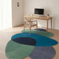 Colorful circular rugs on a wooden floor with a desk and chair in the background.