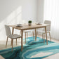 Dining room with a wooden table and chairs on a blue abstract rug.