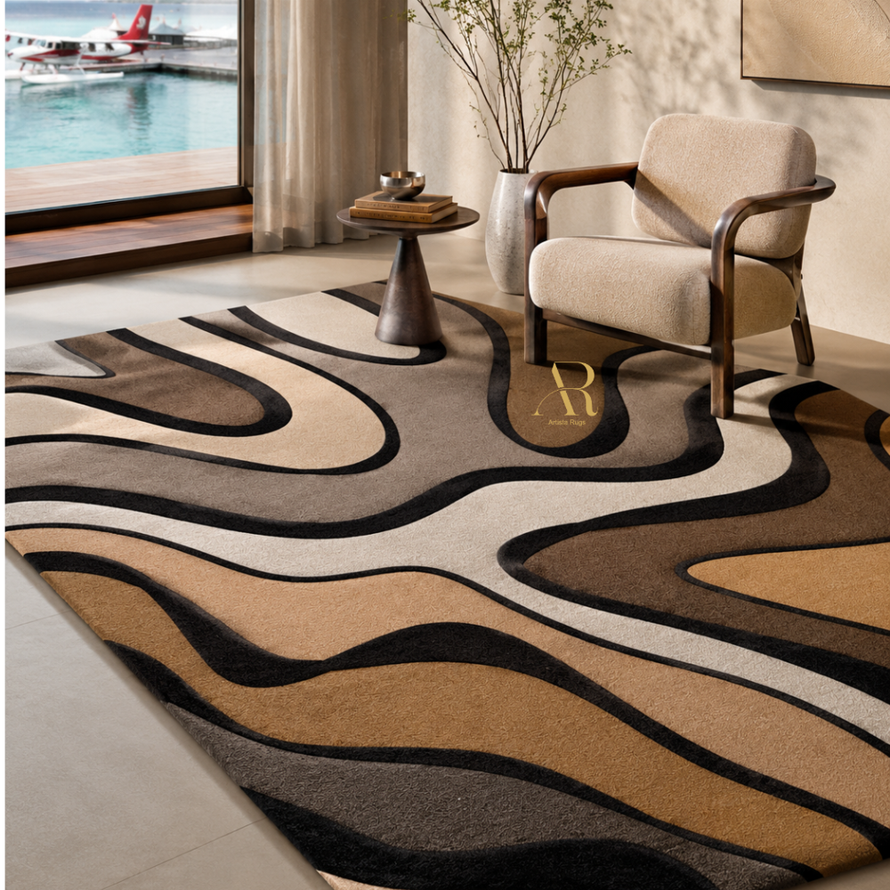 A large area rug with a wavy, organic pattern in beige, brown, black, and cream, styled in a modern living room next to a window overlooking a dock.