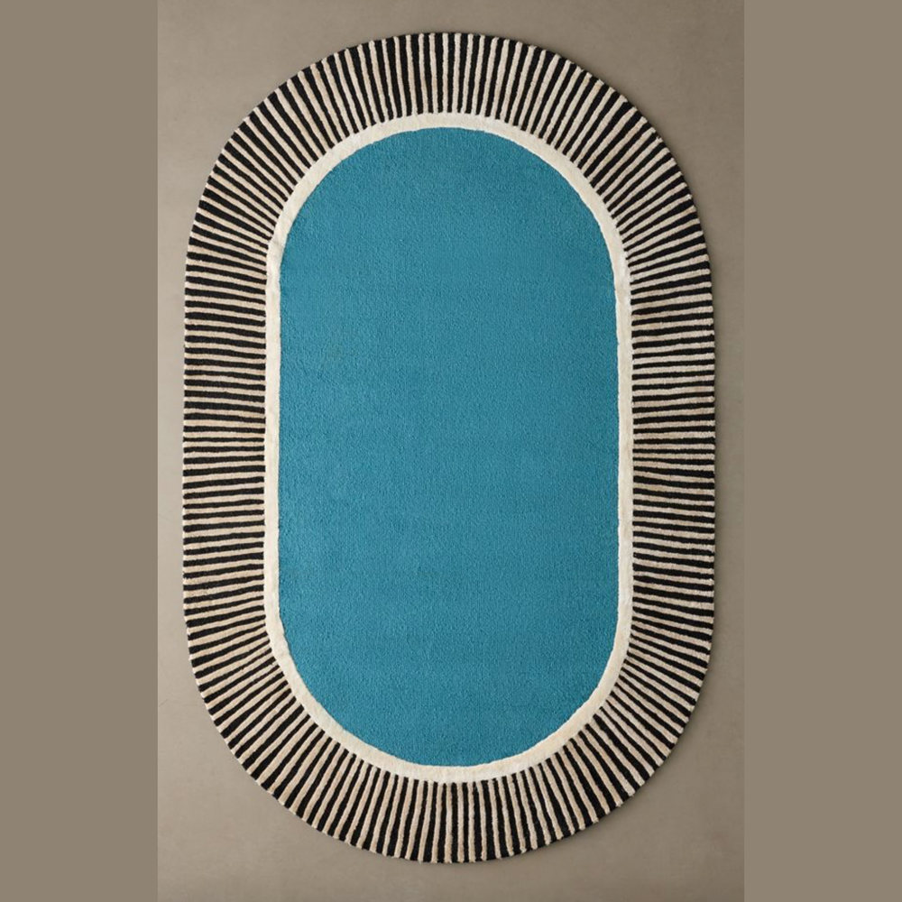 Oval-shaped rug with blue center and black striped border on a beige background
