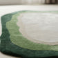 Round green and beige rug on a light floor