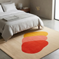 Beige rug with red and yellow abstract design in a bedroom setting