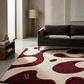 Living room with a patterned rug, sofa, and lamp.