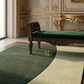 Luxurious room with a green bench and ornate wall decorations