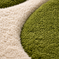 Close-up of a textured green and beige rug