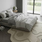Modern bedroom with a bed and decorative rug.