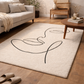 Beige rug with black abstract design in a living room setting
