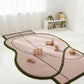 Children's rug shaped like a fish with wooden toys on a white floor.