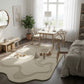 Modern living room with a rug, table, chairs, and decor elements.
