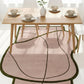 Dining table set with chairs and a decorative rug in a room.