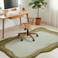 Modern office setup with a desk, chair, and decorative rug.