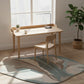 Wooden desk and chair in a bright room with large windows, rug, and plants.