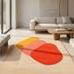 Modern living room with a colorful abstract rug and a beige sofa.
