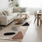 Modern living room with a patterned rug, white sofa, and wooden coffee table.