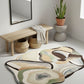 Abstract patterned rug on a light gray floor with a wooden bench and plant in the background.