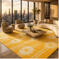 A large yellow area rug with a white daisy and stripe pattern in a modern living room setting with a city skyline view.