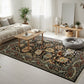 Living room with a decorative rug, coffee table, and sofa.