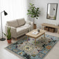 Living room with a beige sofa, coffee table, and decorative rug.