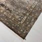 Close-up of a patterned rug on a white floor