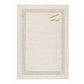 A rectangular cream linen place card with a decorative border of small perforated dots and a gold monogram logo in the top-left corner, shown on a plain white background.