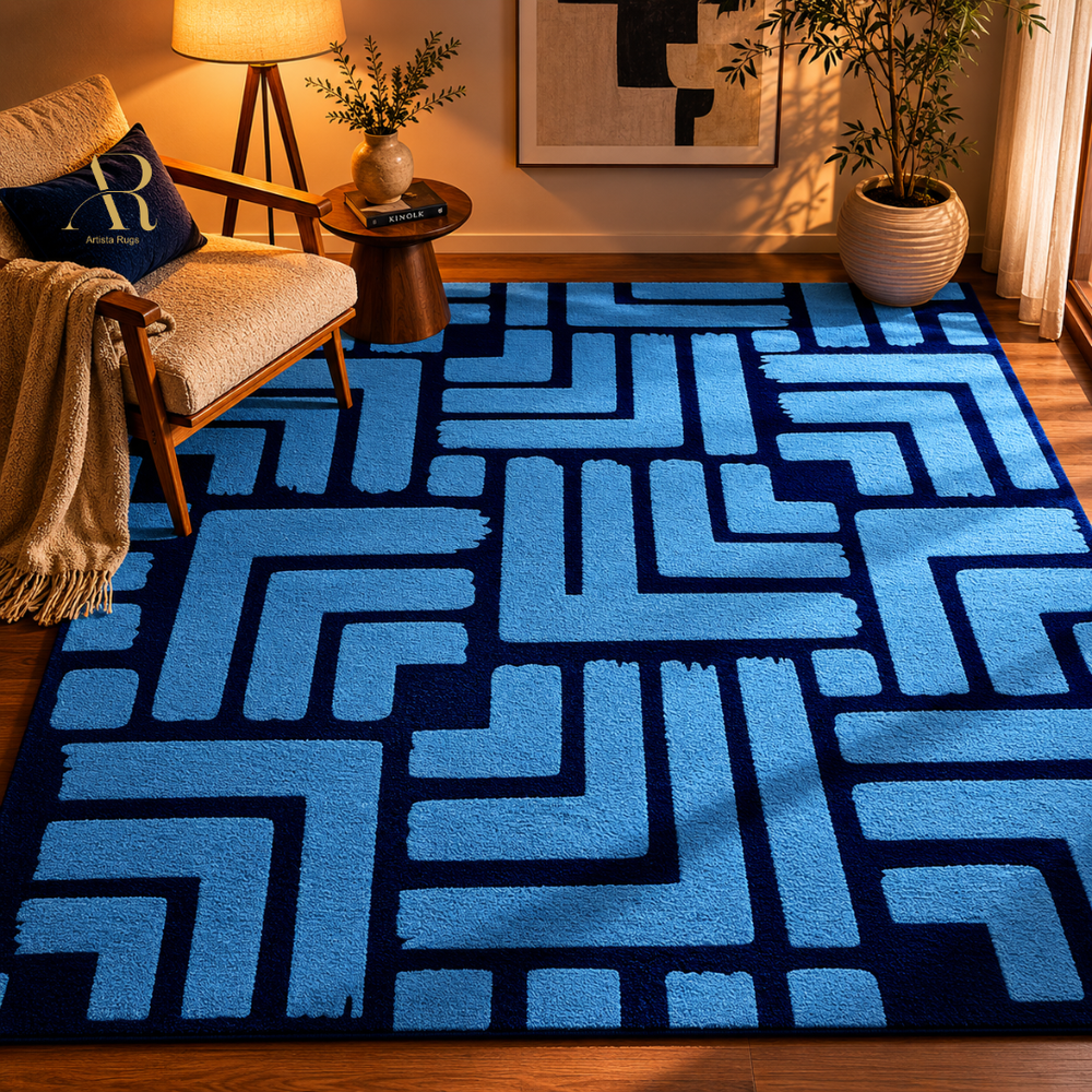 A large area rug with a bold geometric maze-like pattern in light blue and dark navy blue, styled in a warm, modern living room setting.