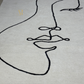 Abstract line art of a face on a gray background