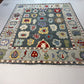Decorative rug with colorful geometric pattern on a white floor