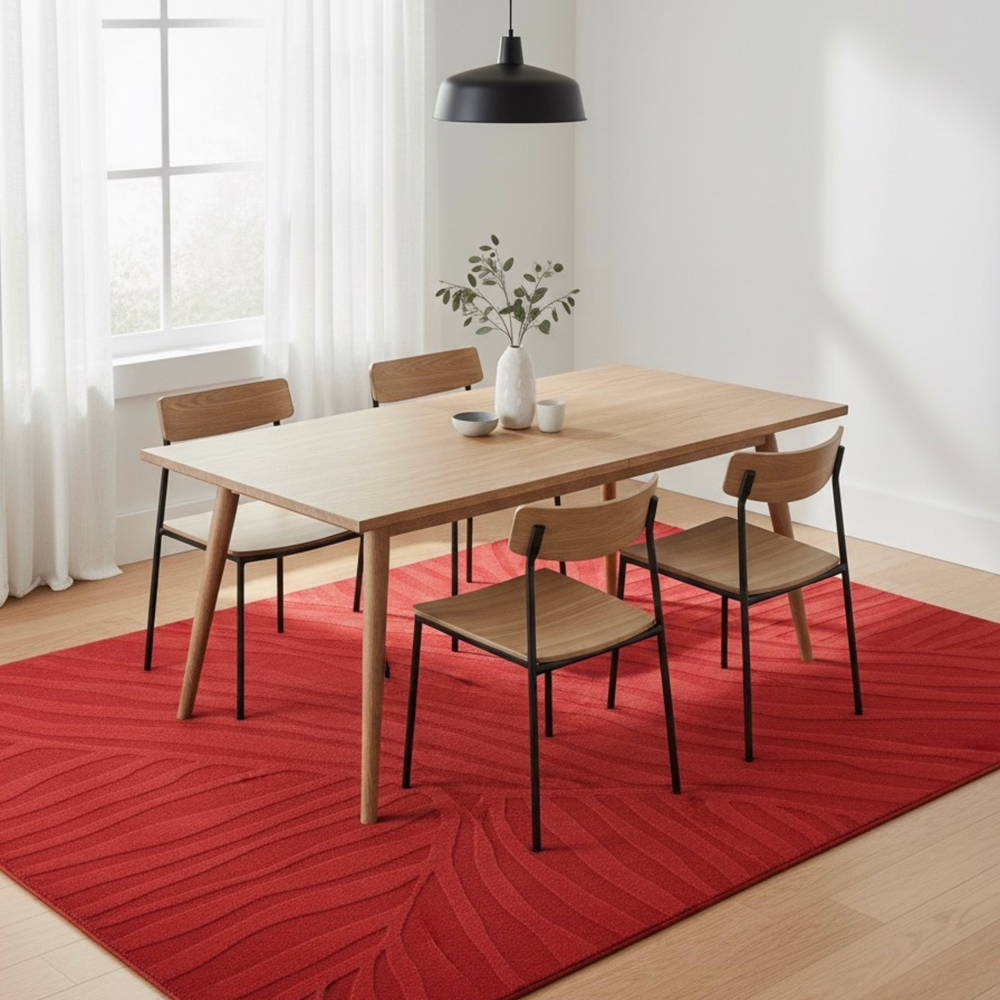 Dining room with wooden table and chairs on a red patterned rug.
