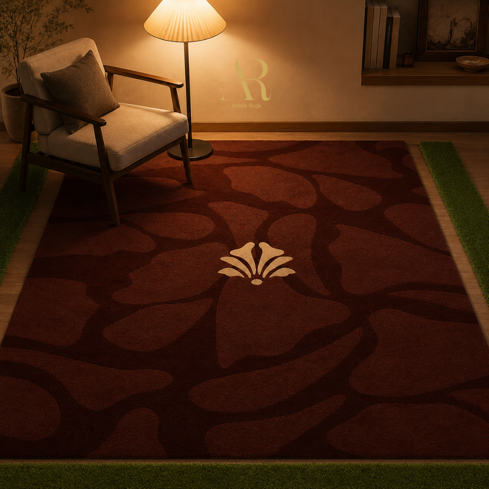 A rectangular area rug with a dark reddish-brown abstract floral pattern and a cream shell motif in the center, styled in a warm, dimly lit living room next to a chair and floor lamp.