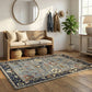Nest living room with wooden bench, decorative rug, and wall hooks.