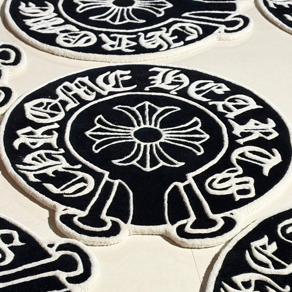 Close-up of circular black and white designs with text on a beige background