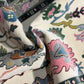 Close-up of patterned fabric with colorful designs on a neutral background