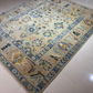 Decorative rug with floral and animal patterns on a tiled floor