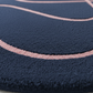 Close-up of a textured blue surface with pink circular patterns