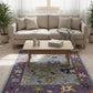 Living room with a beige sofa, coffee table, and colorful rug.