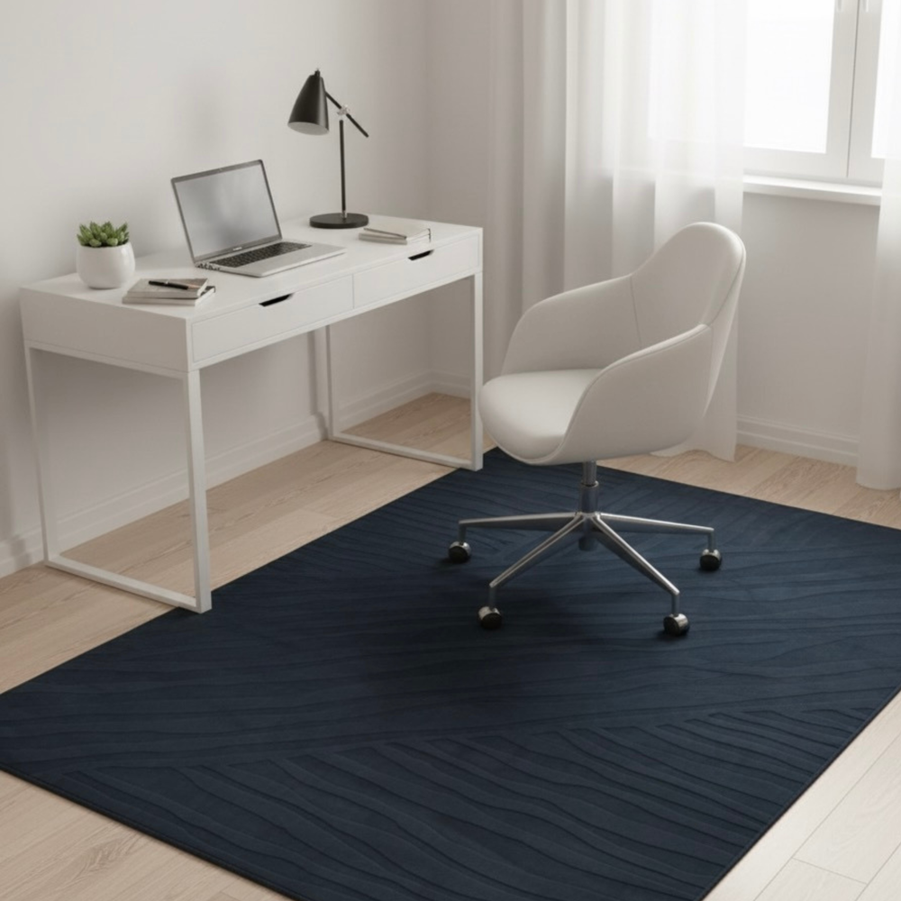 White office desk with chair and laptop on a dark blue rug