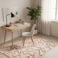 Modern home office with wooden desk, white chair, and decorative rug.