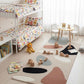 Children's room with bunk bed, toys, and a rug with geometric shapes.