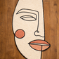Abstract face design on a wooden floor